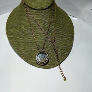 Women`s gold tone charms magnetic necklace.